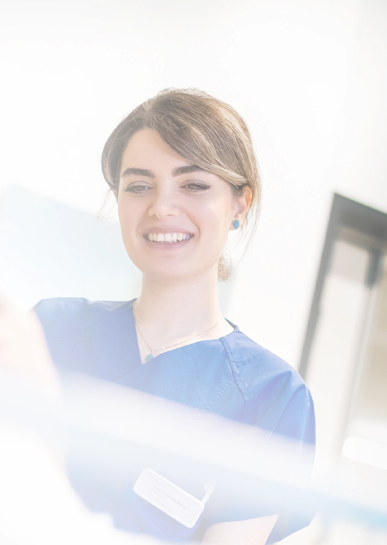 A hospital employee is smiling while talking to a patient (Photo)