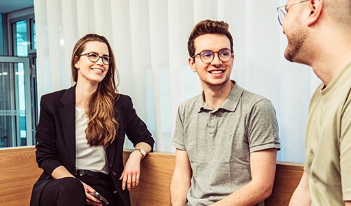 Two men and a woman are engaged in conversation and appear happy (Photo)