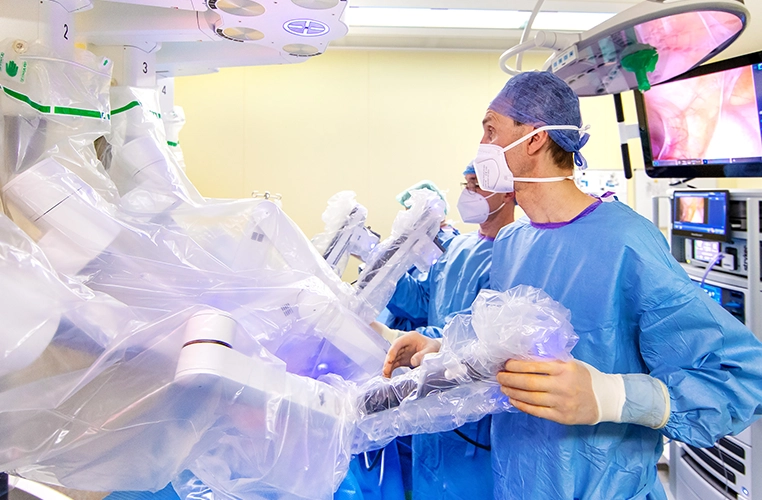 Medical staff in protective clothing, hairnets, and with medical equipment (photo)