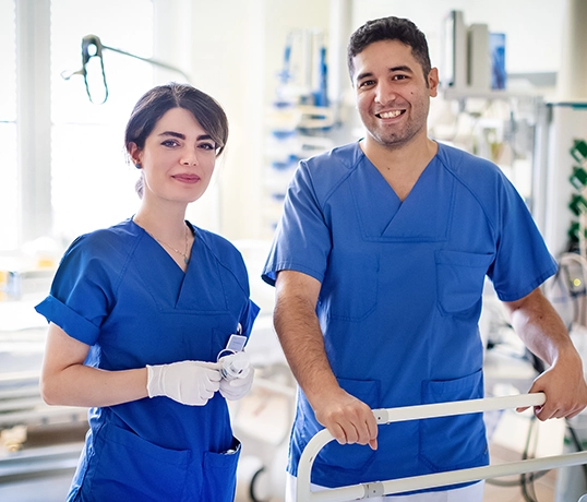 Two employees from the medical field smile at the camera (photo)